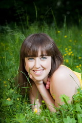 Beauty young woman relaxing in the grass