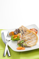 tasty pork chop with corn carrot tomato