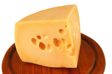 big chunk of yellow cheese on wood plate