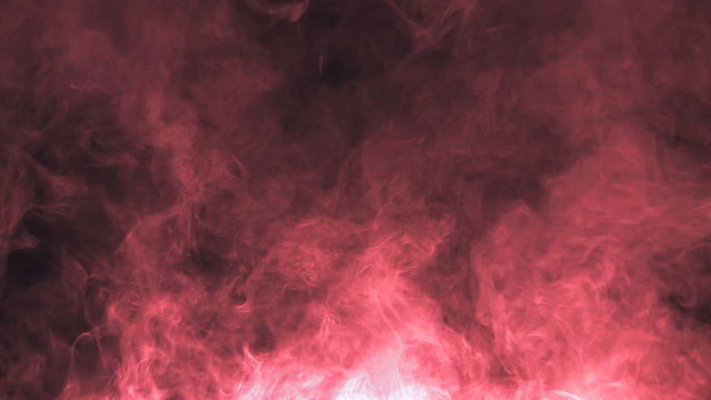 Red smoke rising on black background