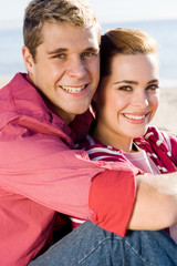 couple cuddling on beach