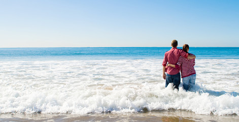 couple standing in waves