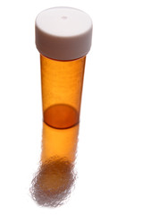 Empty pill container standing on white background