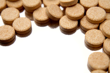 Vitamin C tablets on white background