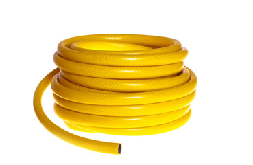 The yellow rubber garden hose on a white background (isolated).