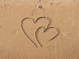 Hearts drawn on sand