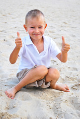 Portrait of little boy showing thumbs up sign