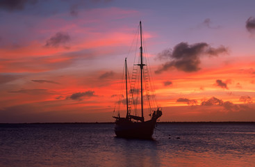 Fototapeta premium Caribbean sunset with sailboat silhouette, Bonaire