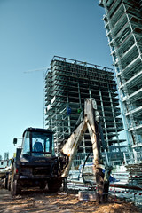Construction site - excavator and scaffolds