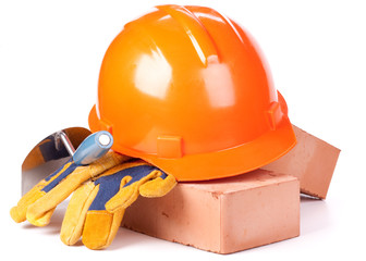 Building bricks, hard hat, trowel and gloves