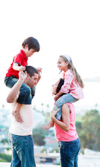 Parents giving their children piggyback rides