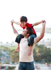 Father giving his son piggyback