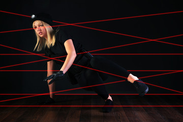 Cat burglar negotiating laser beam alarm system