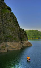 Fototapeta na wymiar Peaceful boat tour on an artificial mountain lake