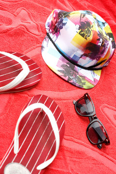 Flip flops, sunglasses and a cap