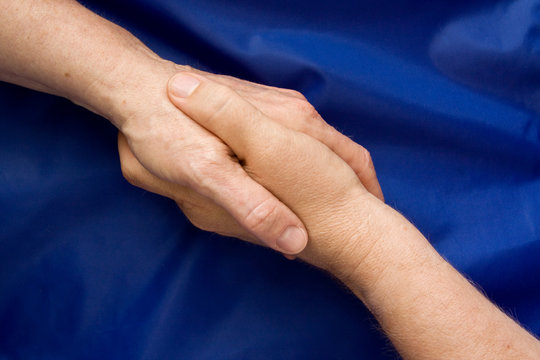 Hand shake against a blue background