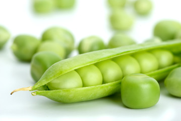 Macro shot of cracked pod and green peas