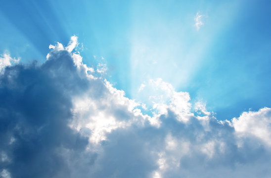 Clouds and a blue sky with a sunbeam shining through