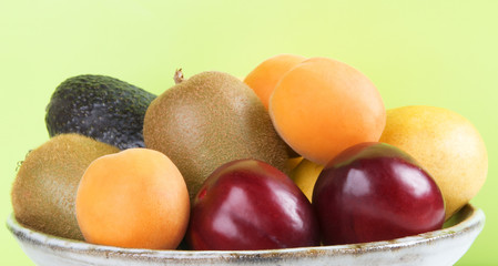 Bowl Of Fruit On Green Background