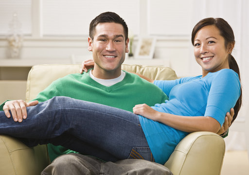Attractive Smiling Couple on Sofa