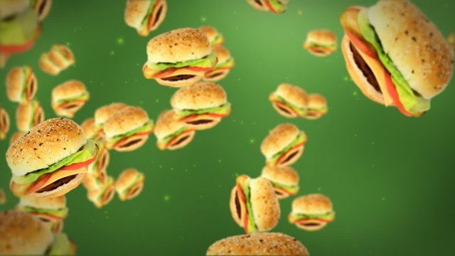 Cheeseburgers flying on green