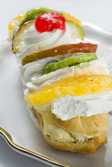Fruity pastry with fruits and whipped cream