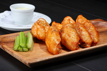 Grilled chicken wings served on wooden board
