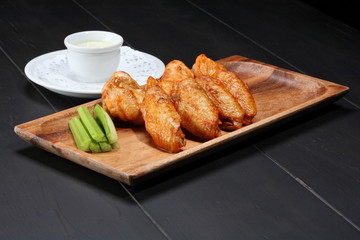 Grilled chicken wings served on wooden board