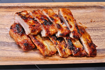 Grilled pork ribs on wooden plate