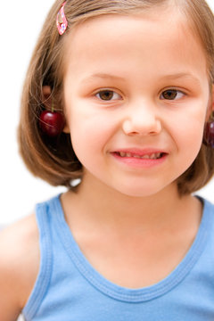 5 years old girl with cherries isolated on white