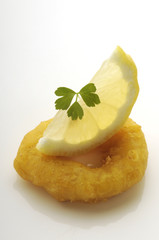 Calamaro fritto con fetta di limone e prezzemolo