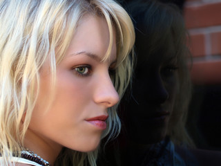 Pretty blond teen profile portrait outdoors window