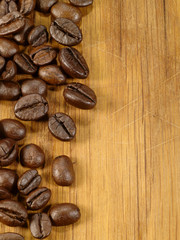 coffee beans on the wooden desk as food background