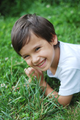 Child laying on the grass
