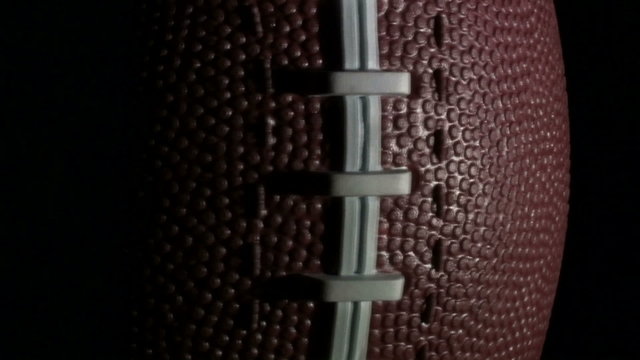 Football rotates against black - HD