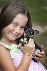 Beautiful little seven-year-old girl with puppy