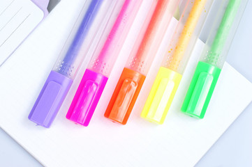Colorful markers over a white background.