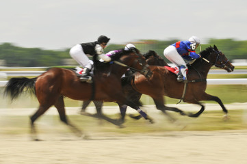 Slow shutter, racing jockeys and horses