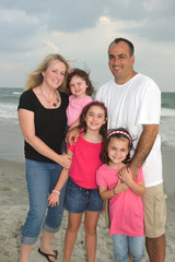 Fototapeta na wymiar Family of 5 at the beach smiling
