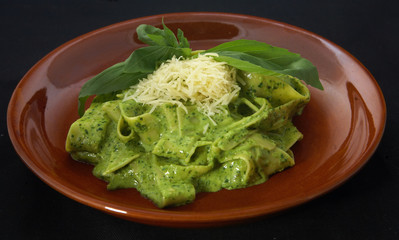 italian pasta with green herbal souse and cheese