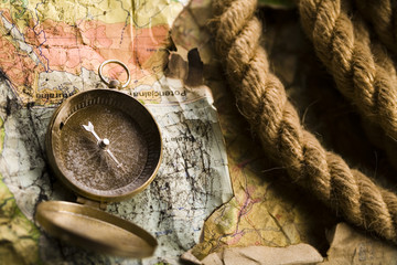 Antique brass compass over old map