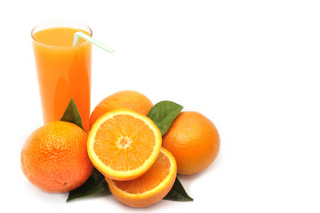 Oranges with green leaves and glass of juice on a white backgrou