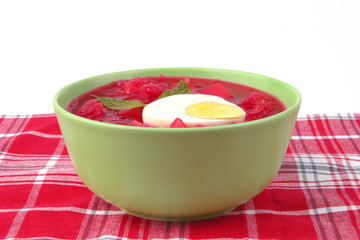 fresh beet vegetable soup in green bowl