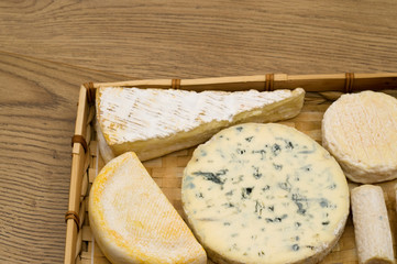 gourmet cheese assortment on wooden background