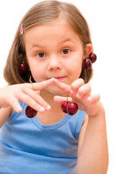 5 years old girl with cherries isolated on white