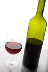 red wine glass and bottle