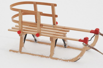 wooden child  sledge  on the snow