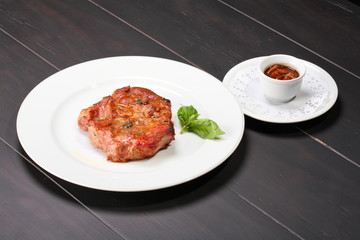Grilled pork chop on a white plate