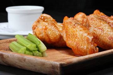 Grilled chicken wings served on wooden board