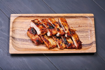 Grilled pork ribs on wooden plate